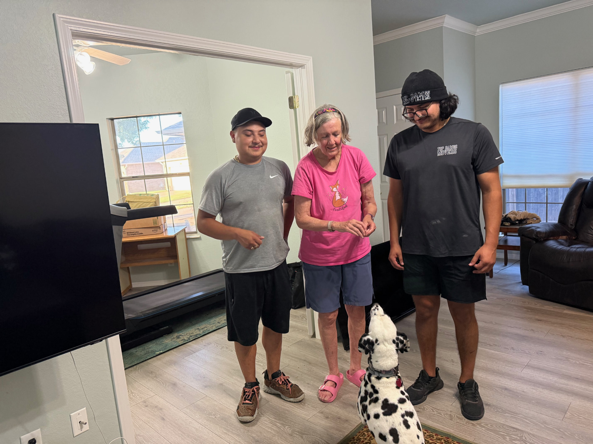 Top Dawg Movers crew with a happy customer and her dog inside an Oklahoma City home